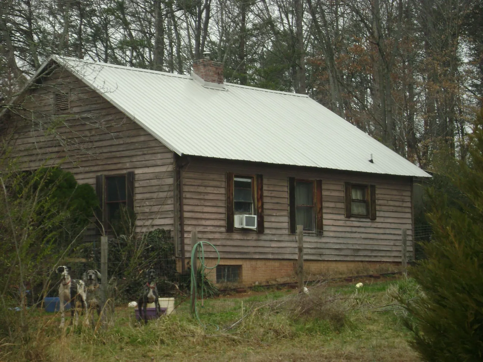 White metal roof on an old wood sided farmhouse, from a Metal Roof Installation job in Thompson